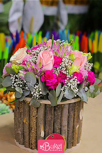 Mixed pink flowers in a wooden box