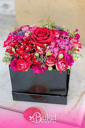 Rose and mixed decorative flowers in a box
